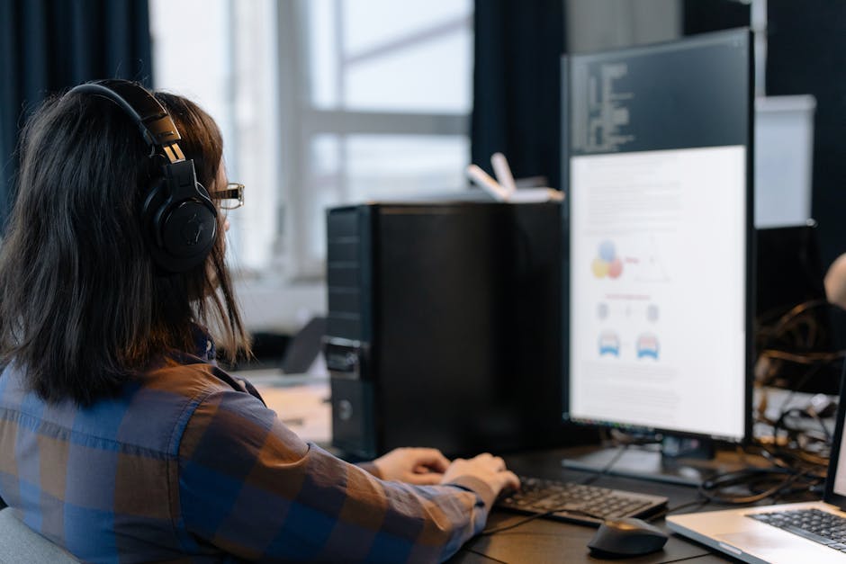 IT professional working on a computer in a modern office